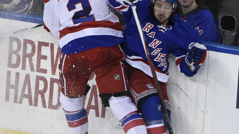 Rangers vs. Capitals 32 Washington Capitals defenseman Matt Niskanen checks New York Rangers right wing Mats Zuccarello against the boards in the second period of an NHL hockey game at Madison Square Garden on Sunday, March 29, 2015.
