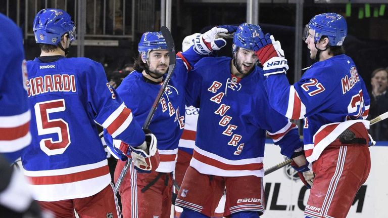 Rangers vs. Capitals 48 New York Rangers center Derick Brassard, second from right, celebrates with teammates after scoring against the Washington Capitals in the first period of a game at Madison Square Garden on Sunday, March 29, 2015.