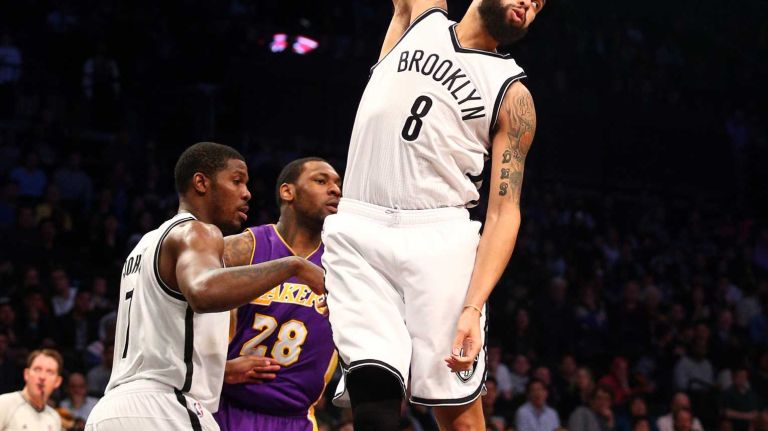 Brooklyn Nets point guard Deron Williams grabs a rebound in front of Los Angeles Lakers power forward Tarik Black during the fourth quarter at Barclays Center on Sunday, March 29, 2015.