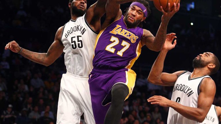 Los Angeles Lakers center Jordan Hill grabs a rebound against Brooklyn Nets small forward Earl Clark and Brooklyn Nets shooting guard Alan Anderson during the fourth quarter at Barclays Center on Sunday, March 29, 2015. 