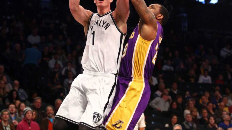 Brooklyn Nets center Mason Plumlee shoots against Los Angeles Lakers power forward Tarik Black during the second quarter of a game at Barclays Center on Sunday, March 29, 2015.
