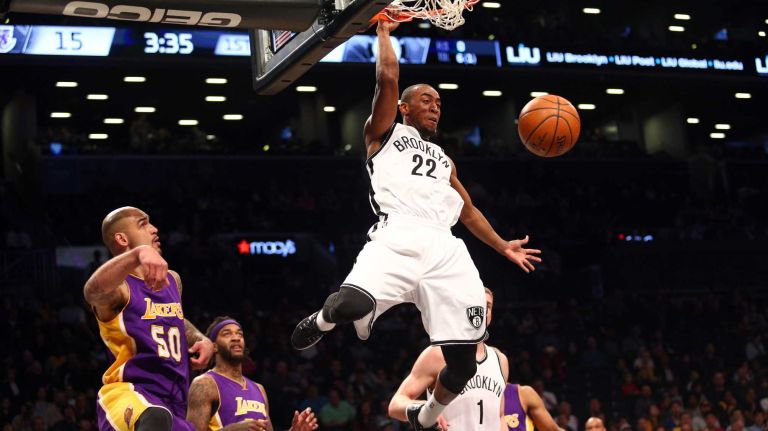 Brooklyn Nets shooting guard Markel Brown #22 dunks over Los Angeles Lakers center Robert Sacre #50 during the first quarter of a game at Barclays Center on Sunday, March 29, 2015.