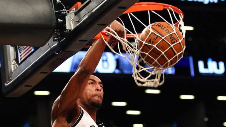 Brooklyn Nets shooting guard Markel Brown #22 dunks over Los Angeles Lakers center Robert Sacre #50 during the first quarter of a game at Barclays Center on Sunday, March 29, 2015.