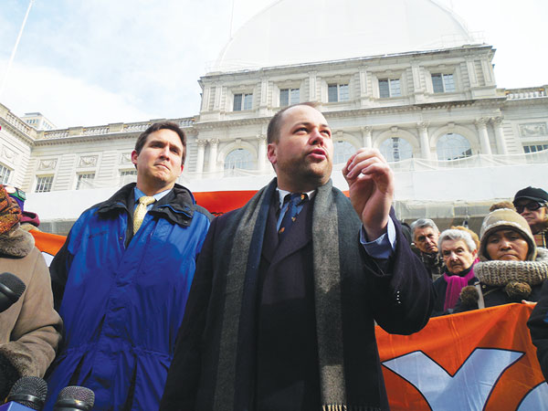 Corey Johnson, right, encouraged tenants to “get on the bus” and lobby in Albany to close loopholes in the rent laws.   Photo by Gerard Flynn