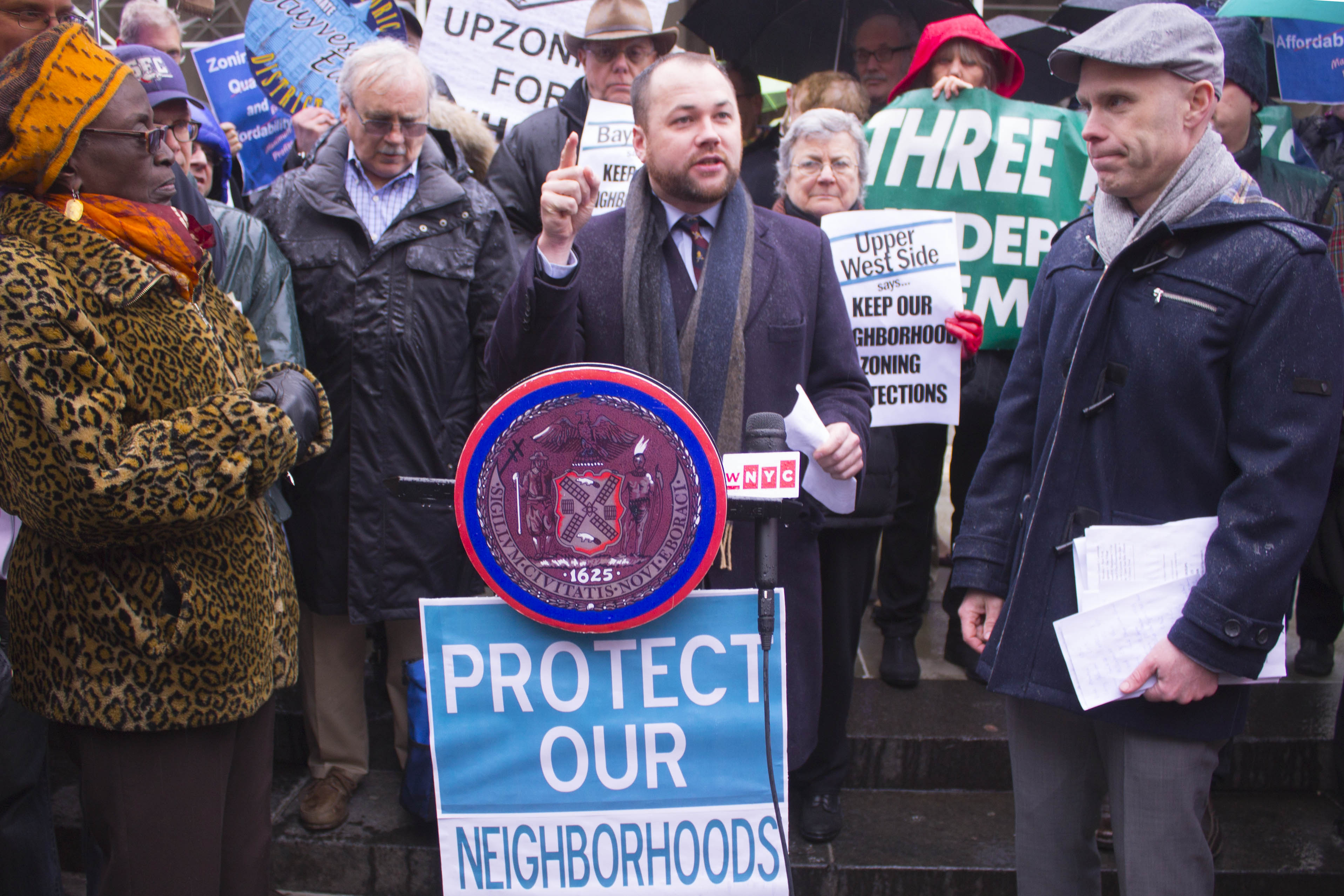 Councilmember Corey Johnson, at podium, and G.V.S.H.P Director Andrew Berman, at right, were among the speakers at a rally before the meeting. The advocates and politicians criticized the proposed changes and said the public-review process is moving way too fast.