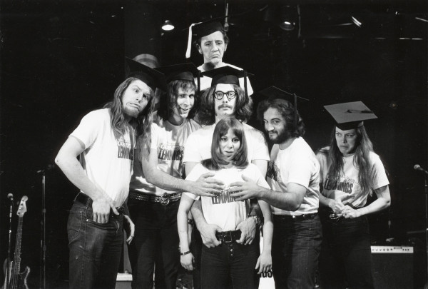 Courtesy of National Lampoon L–R: Garry Goodrow, Peter Elbling, Chevy Chase, Chris Guest, John Belushi, Mary-Jennifer Mitchell and Alice Peyton. 