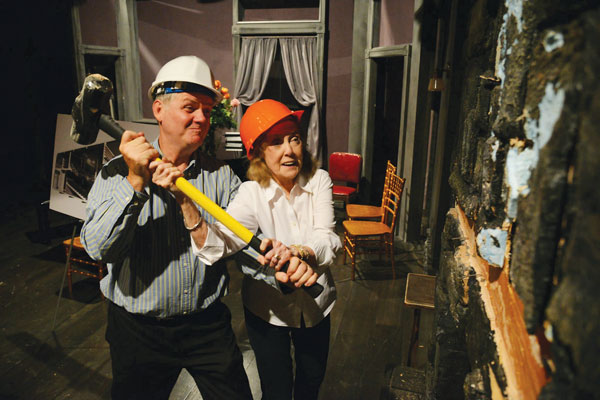 Photo by James Higgins Pardon us for hammering it home: Chelsea Now’s profile of the Irish Repertory Theatre’s temporary move to Union Square won Second Place in the Better Newspaper Contest’s Feature Story category — essentially forcing us to write this really long photo caption. You think this is bad? Check out the length of our headlines! Pictured: Irish Rep co-founders Charlotte Moore and Ciarán O’Reilly administer a little tough love to the wall of their W. 22nd St. theatre.