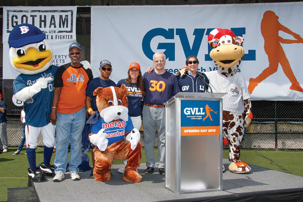 From left, Sandy the Seagull, the Brooklyn Cyclones mascot; Henry Guiden, G.V.L.L. head umpire; Carlo Saldana, Majors Division coach; Carin Ehrenberg, G.V.L.L. president; Art Henkel, Upper Division coordinator; Mike De Rosa, Minors Division head umpire; and Scooter the Cow, the Staten Island Yankees mascot. Kneeling in front is the new, still-nameless Pier 40 baseball mascot.   Photo by Howard Barash Photography
