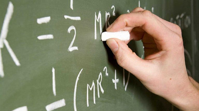 Ex-teacher: I taught by day and partied by night 2 A teacher writing on a chalk board.