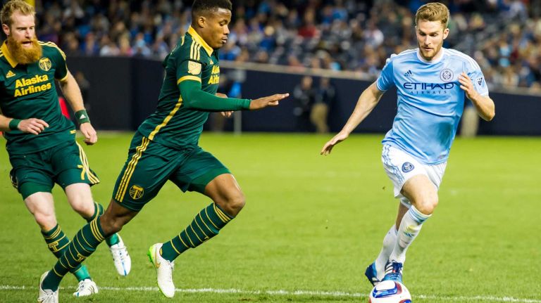 New York City FC forward Patrick Mullins (14) is pursued by Portland Timbers defender Alvas Powell (2) in a game at Yankee Stadium on Sunday, April 19, 2015.