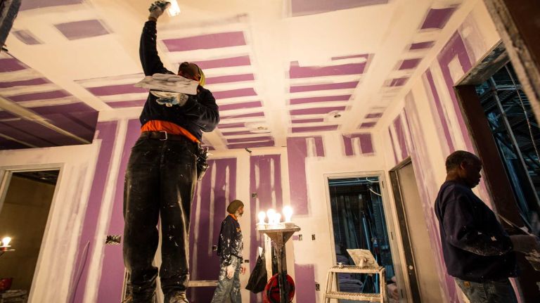 Tapers are plastering the seams and screws on one of the nearly completed modules by Capsys Corp., located in the Brooklyn Navy Yard, part of New York City's micro apartment project. Once completed the apartments will be moved to Manhattan. April 9, 2015.