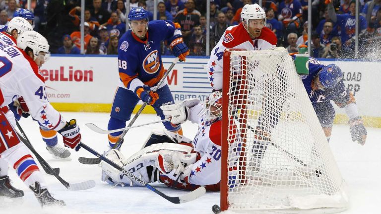 John Tavares #91 and Ryan Strome #18 of the New York Islanders miss a first-period scoring chance against Braden Holtby #70 of the Washington Capitals during Game 3 of the Eastern Conference quarterfinals at Nassau Coliseum on Sunday, April 19, 2015.
