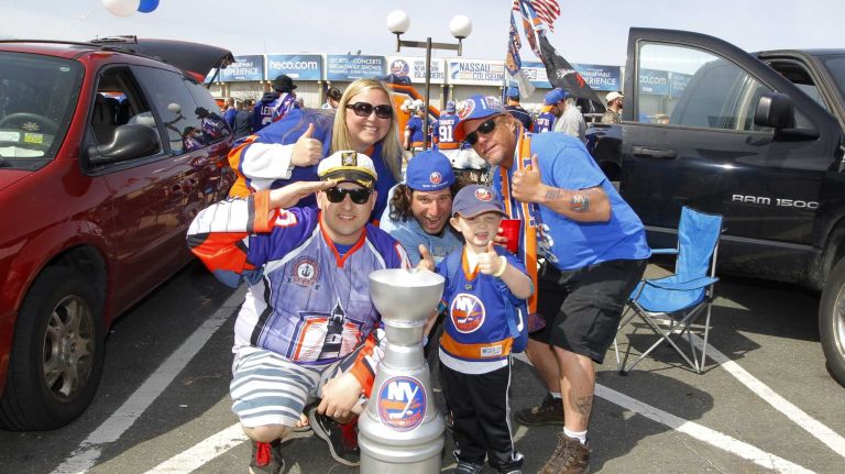 New York Islanders fans pose for a photograph before Game 3 of the Eastern Conference quarterfinals against the Washington Capitals at Nassau Coliseum on Sunday, April 19, 2015.