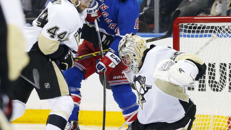 Marc-Andre Fleury and Taylor Chorney of the Pittsburgh Penguins defend against Tanner Glass of the New York Rangers in the second period during Game 1 of the Eastern Conference Quarterfinals at Madison Square Garden on Thursday, April 16, 2015.