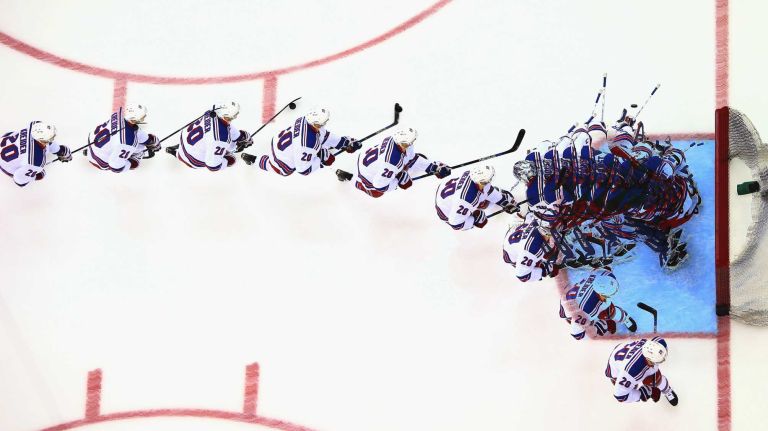 Chris Kreider and Henrik Lundqvist of the New York Rangers skate in warm-ups prior to the game against the New Jersey Devils at the Prudential Center on April 7, 2015 in Newark, N.J.