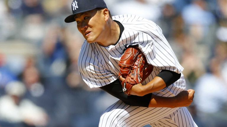 Masahiro Tanaka #19 of the New York Yankees pitches early in a game against the Toronto Blue Jays during Opening Day at Yankee Stadium on Monday, April 6, 2015 in the Bronx Borough of New York City.