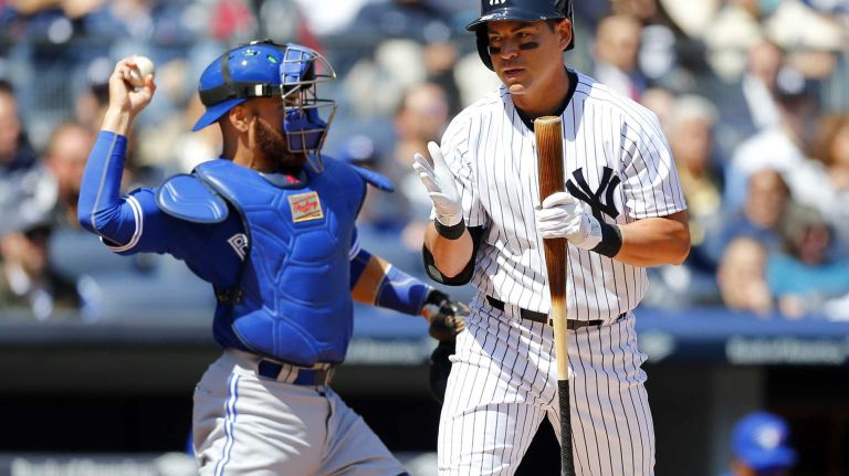 Jacoby Ellsbury #22 of the New York Yankees reacts after striking out in the first inning as Russell Martin #55 of the Toronto Blue Jays returns the ball to his pitcher during Opening Day at Yankee Stadium on Monday, April 6, 2015 in the Bronx Borough of New York City.