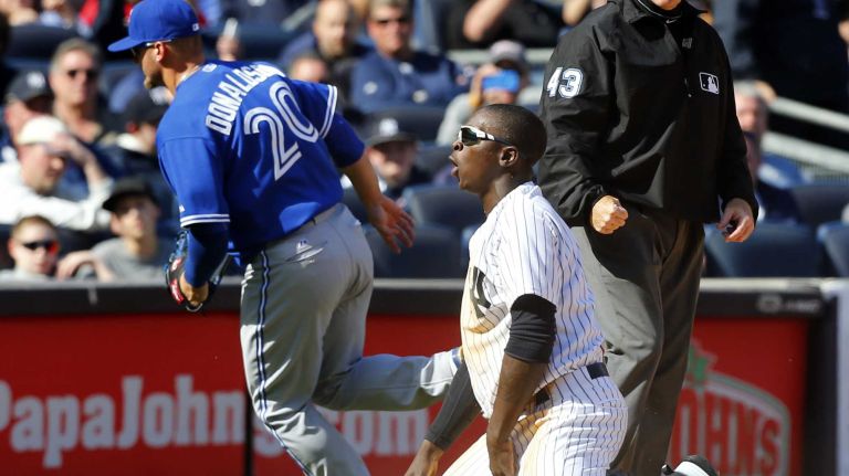 Didi Gregorius #18 of the New York Yankees reacts after heis caught stealing third base to end the eighth inning by Josh Donaldson #20 of the Toronto Blue Jays during Opening Day at Yankee Stadium on Monday, April 6, 2015 in the Bronx Borough of New York City.