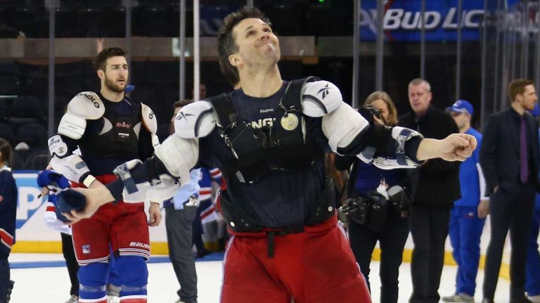 NHL deputy commissioner Bill Daly presents the Presidents' Trophy to Ryan McDonagh #27 of the New York Rangers prior to a game against the Ottawa Senators at Madison Square Garden on April 9, 2015.