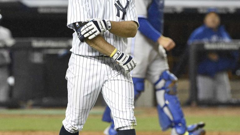 Yankees left fielder Brett Gardner grabs his arm after he is hit by a pitch by Toronto Blue Jays relief pitcher Brett Cecil in the eighth inning on April 8, 2015.