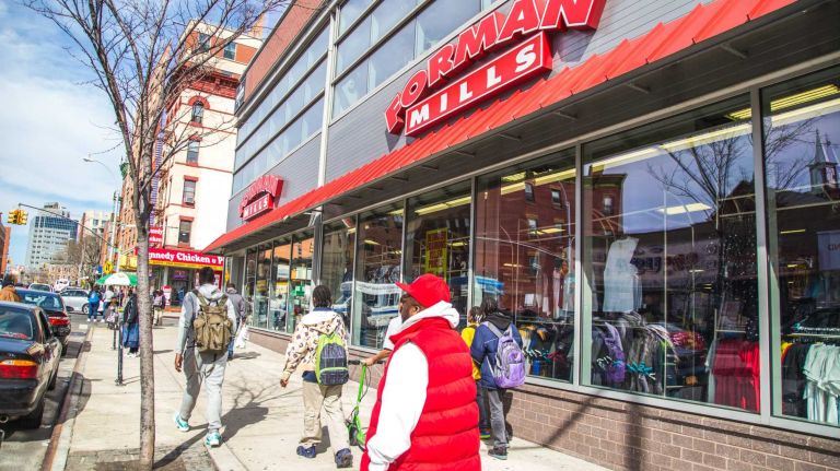 Pedestrians walk by Foreman Mills in the Melrose neighborhood in the Bronx on April 15, 2015. 