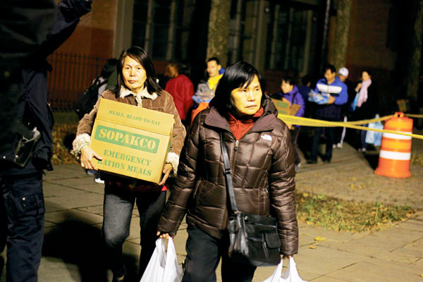 In November 2012, Smith Houses residents grabbed emergency rations trucked in by the National Guard three days after Hurricane Sandy hit, knocking out electricity in southern Manhattan.  File photo