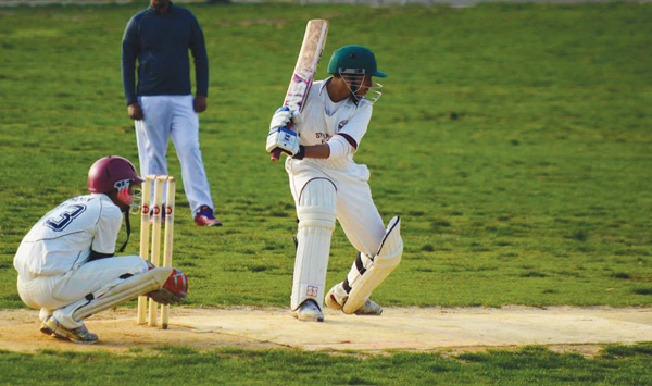 A Stuyvesant player watches out for the sticky wicket.