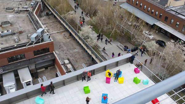 People enjoyed the museum’s fifth-floor balcony, which overlooks both the meat co-op building, left, and the High Line, center.