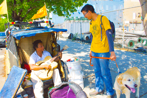Curbside Homestead, and Hope, for Former Chelsea Merchant 2 Randy Morris, seen here with dog walker Alex Middleton of Brooklyn, receives help from neighborhood regulars who bring food, money and conversation. Photo by Zach Williams.