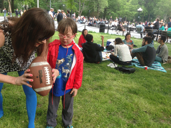 The All-New Adventures of an Aging Urban Elf 4 Rev. Jen plays football with Walter, adorable spawn of Art Stars Tia and Warren. Photo by George Courtney.
