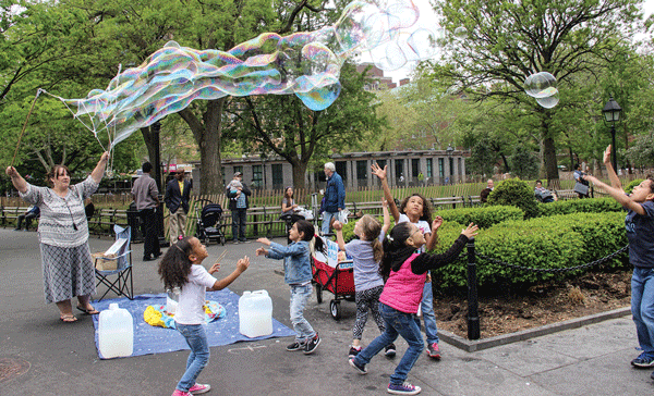 The “Bubble Lady” is really “blowing up” lately. She has kids in the park going bananas for her supersized sudsy creations.    Photo by Tequila Minsky