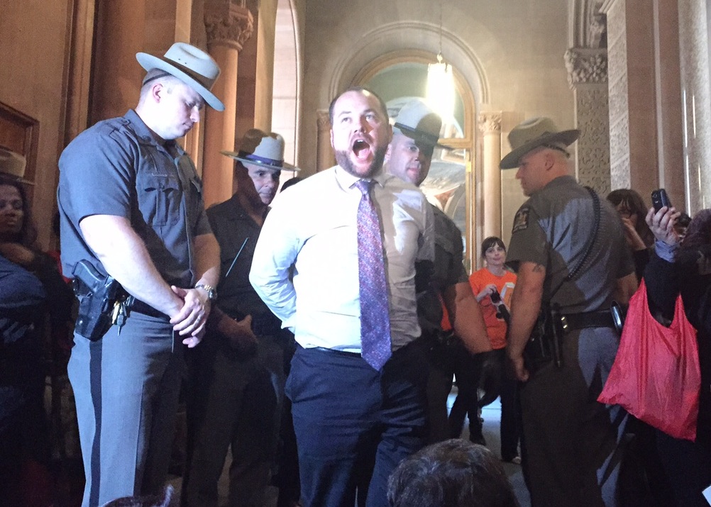 Corey Johnson being arrested in Albany on Wednesday during a planned sit-in protest outside the governor’s office.