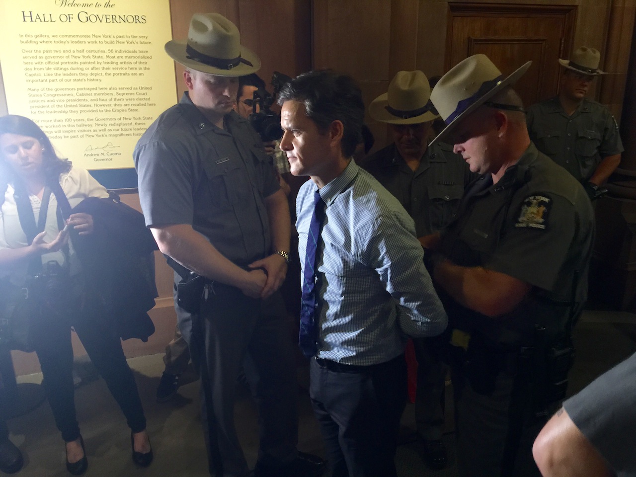 Brad Hoylman being arrested in the state capitol outside the governor's office.