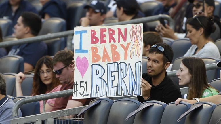 Fans hold a sign during a ceremony to honor former New York Yankees centerfielder Bernie Williams before a game between the Yankees and the Texas Rangers at Yankee Stadium on Sunday, May 24, 2015.
