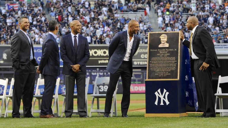 From left, former New York Yankees Andy Pettitte, Jorge Posada, Mariano Rivera, Derek Jeter and Bernie Williams react during a ceremony to retire Williams' No. 51 before a game between the Yankees and the Texas Rangers at Yankee Stadium on Sunday, May 24, 2015.