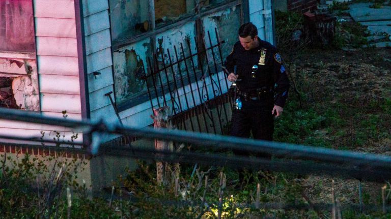 Police officers investigating the area peered into yards and passing vehicles and told residents to stay in their homes.