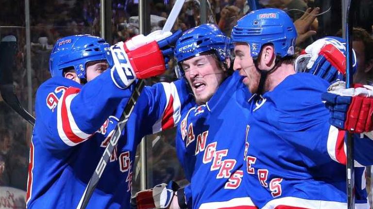 Kevin Hayes #13 of the New York Rangers celebrates with his teammates after scoring a goal in the second period against the Washington Capitals in Game 7 of the Eastern Conference semifinals during the 2015 NHL Stanley Cup playoffs at Madison Square Garden on May 13, 2015.
