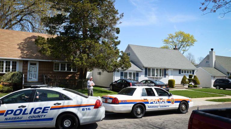 A Nassau County police car sits outside the Massapequa home of NYPD Officer Brian Moore, 25, on Sunday, May 3, 2015. The officer, who was shot Saturday while working in Queens Village, is in Jamaica Hospital Medical Center.