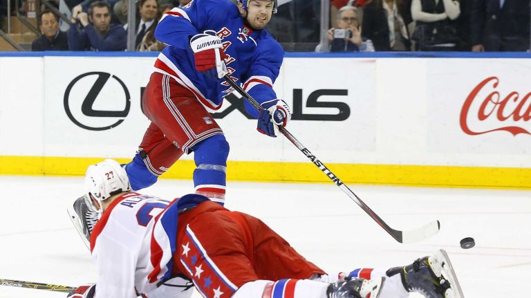 Rangers vs. Capitals: Game 2 of round 2 of Stanley Cup playoffs 29 Rick Nash #61 of the New York Rangers shoots the puck in the third period past Karl Alzner #27 of the Washington Capitals during Game 2 of the Eastern Conference semifinals at Madison Square Garden on Saturday, May 2, 2015.