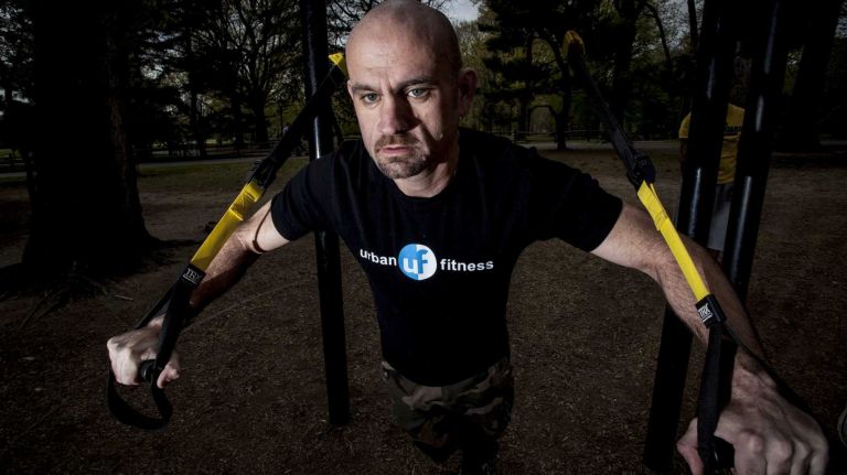 Fitness trainer Jason Keigher demonstrates his exercise program inCentral Park.