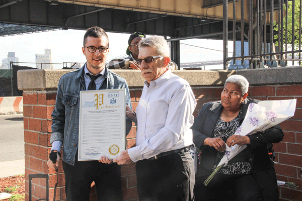 Victor Papa, right, received a proclamation from state Senator Daniel Squadron’s representative that honored the Two Bridges Neighborhood Council on the street co-naming.