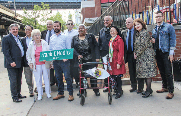 At the dedication, Frank Modica’s son, Sean, and Frank’s wife, Kathleen, held a copy of the sign that was given to them to keep. Also among those at the event were, from right, Judy Rapfogel, chief of staff for Assemblymember Sheldon Silver; Mark Handelman, executive director of Hamilton-Madison House; Councilmember Margaret Chin, and Elaine Hoffman, with flowers.  Photos by Tequila Minsky