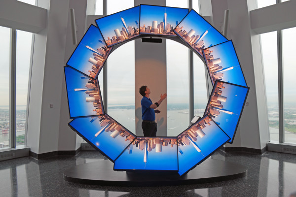 The views from 1 W.T.C. Observatory (a.k.a. Freedom Tower) 2 On the same floor as the main Observatory space is "City Pulse." An "ambassador" situated around a ring of high definition video monitors, guides visitors to sites around the city. The ambassador wears gesture recognition technology on their arm and can summon imagery on the screen. Downtown Express photo by Milo Hess.