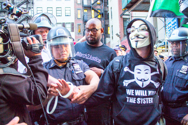 One of the first arrests on April 14 was of a man who disrupted Brooklyn-bound traffic in a lane leading onto the Brooklyn Bridge.  Photo by Zach Williams