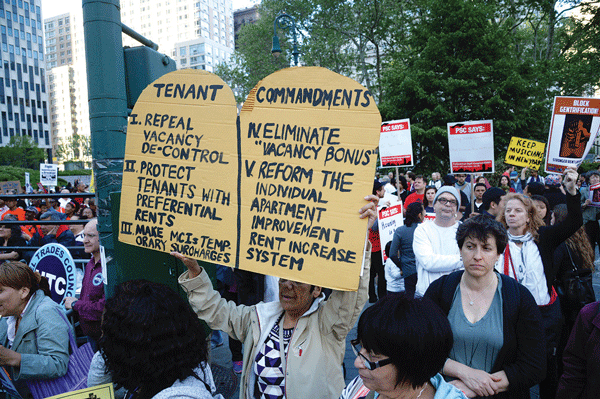 A marcher with the “Holy Grail” of reforms that tenants seek.  Photos by Jefferson Siegel