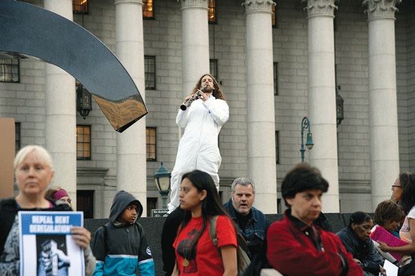 A man on a clarinet “blew his horn” in favor of tenants’ rights.