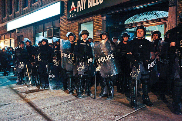 A phalanx of Baltimore police, sporting plexiglas shields, leg guards and extra-long clubs, held a line on the streets during the turmoil.