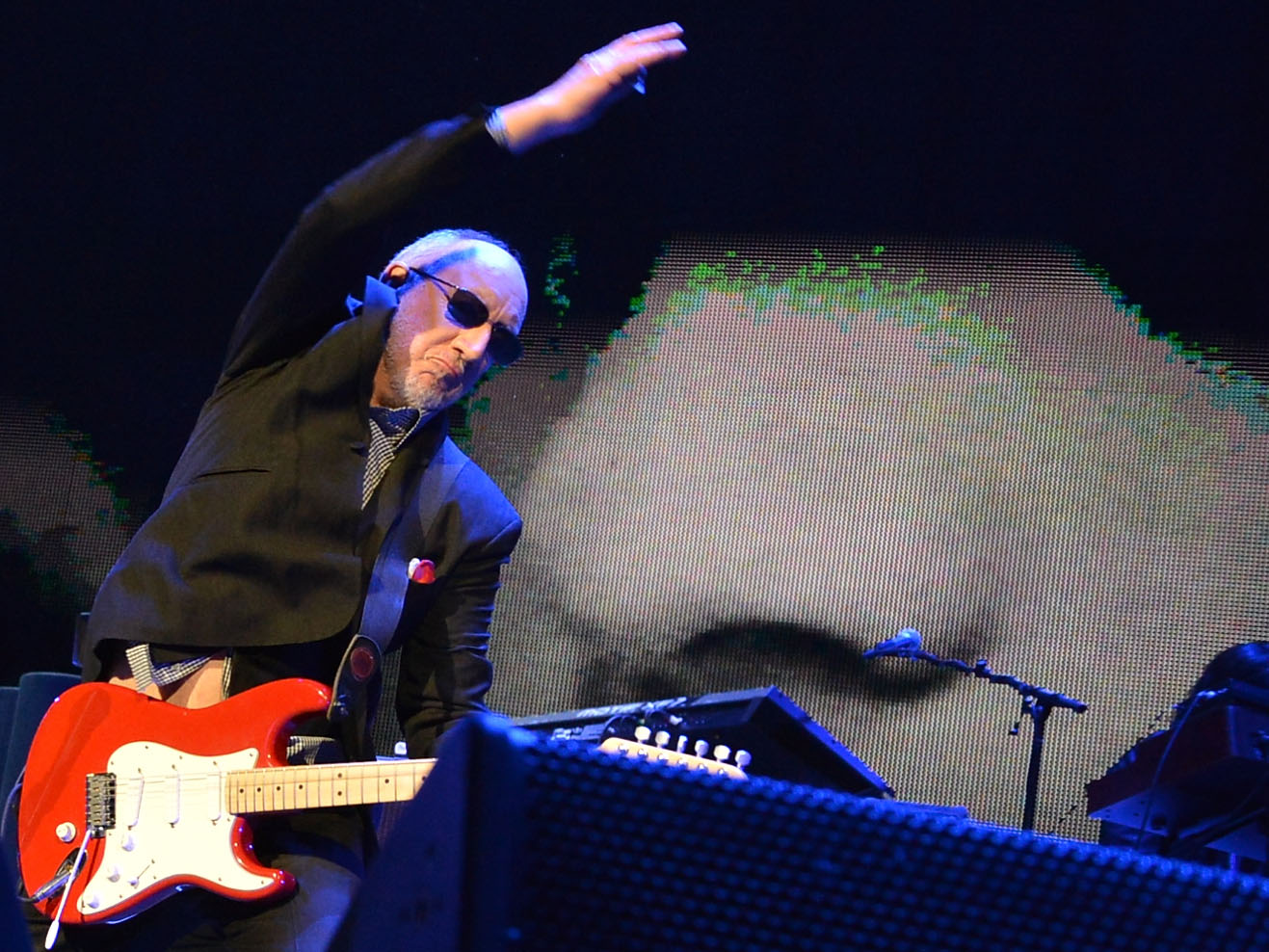 Pete Townshend doing his signature windmill guitar strum. 