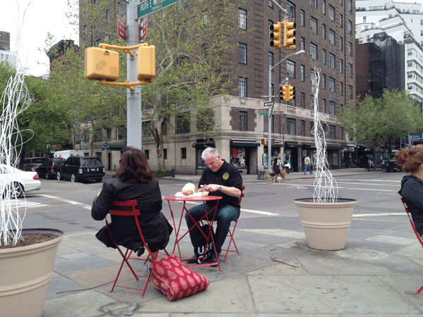 People can now munch a lunch, sit and relax or chat with a friend on Ruth Wittgenstein Triangle. At right and left are two parts of John Schriner’s “In Flux” art installation.