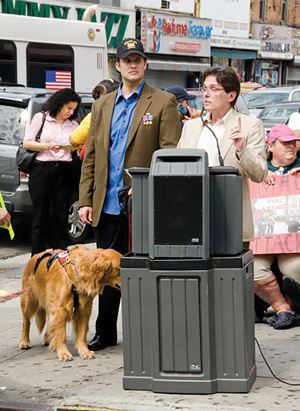 From right, Michael Schweinsburg, director of Disability Pride NYC; Luis Motalvan and his service dog, Tuesday; and Edith Prentiss, president of 504 Democratic Club and a DPNYC committee member, at a protest on Montalvan’s behalf. A decorated Iraq War veteran, Montalvan was reportedly physically assaulted — with a garbage can lid — by a McDonald’s employee after entering one of the chain’s restaurants with Tuesday.